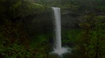 Waterfall Empties Into Pool In Misty Temperate Forest