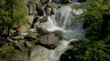 Waterfall Flows Over Boulders In Forest