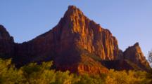 Steep Red Rock Formations Lit By Golden Sunlight