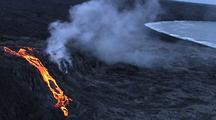 Aerial View Of Lava Flowing From Volcano Near Water's Edge