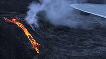 Aerial View Of Molten Lava Flowing From Volcano Near Water's Edge