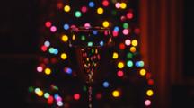 Glass Of Sparkling Champagne With Christmas Tree Lights