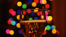 Glass Of Sparkling Champagne With Christmas Tree Lights