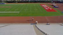 Person Jogs On Track Around Football Field At Santa Barbara City College