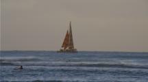 Sailboat Near Shore With Many People, Others In Water