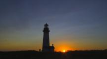 Lighthouse Sunrise On Rugged Coast