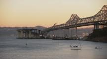 Shot From Treasure Island Of Oakland With The Oakland Bay Bridge And View Of Construction Of A New Bridge. Boats In The Water.