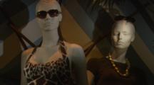 Female Mannequins Modeling Sunglasses And Dresses In An Upscale Womens Clothing Shop Window Display.