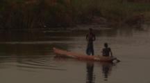 Children Paddling In Dugout Canoes