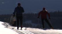 People Cross Country Skiing And Skate Skiing On Groomed Trail