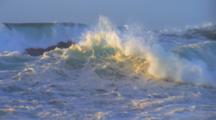 Waves Crash On Rocky Shore During Winter Storm