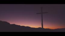 Silhouetted Cross Seen At Sunrise Amongst Distant Hills. Atmospheric, Hope, Religion, Spirituality.
