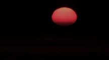 Time Lapse, Close Up Red Sun Sets On Horizon