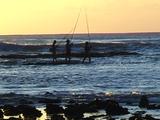 Local Fishermen On Reef Fishing Sunset