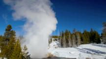 Riverside Geyser Erupts Along The Firehole River In Winter In Yellowstone National Park