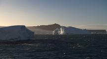 Antarctic Ocean Icebergs With Mountains Behind