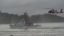 Coast Guard Patrol Boat With A Coast Guard Helicopter In Hot Pursuit.