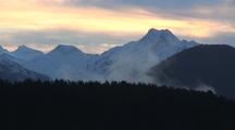 Sunrise/ Drifting Clouds Over Towering Peaks