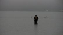 A Lonely Fly Fisherman Fishes In The Rain.