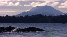 Humpback Whales Spouting Near A Volcano