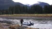 Hiker/Hunter Pulling A Raft Up A Stream