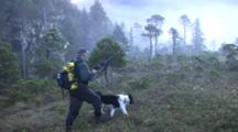 Hiker/Hunter Enters A Muskeg With His Dog
