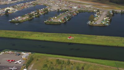 Floatplane Takes off,others parked at Edge of Lake Hood,Seaplane Base