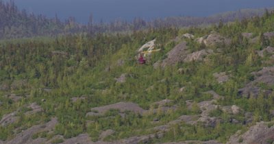 Aerial View of Helicopter With Heligimbal Camera Flying Over Alaska Forest