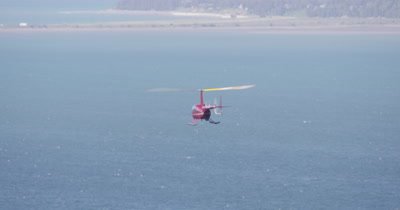 Aerial View of Helicopter With Heligimbal Camera Flying Over Water