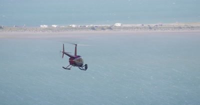 Aerial View of Helicopter With Heligimbal Camera Flying Over Water