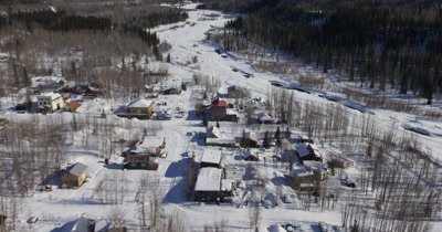 Aerial Over Alaska Village,Person Cross Country Skiing with Dog Near Houses