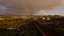 A Rainbow Arches Over A Village In The Azores.