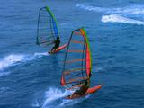 Two Men Windsurfing Waves And Jumping