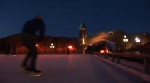 Quebec City, Canada, Ice Skating In The Evening At Place D' Youville, QuéBec, Port-St-Jean In Background