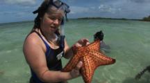 Kids Snorkel In Calm Water On Sand Bar While Participating In An Eco-Tour, One Holds Up Giant Sea Star And Returns It To The Ocean