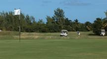 Wide Shot Of Golfers On Course With Golf Cart, Golf Ball Lands On Green
