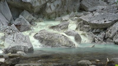 4K Mineral stream, sulfur spring, from rock face empties in to fresh water creek - NOT Colour Corrected