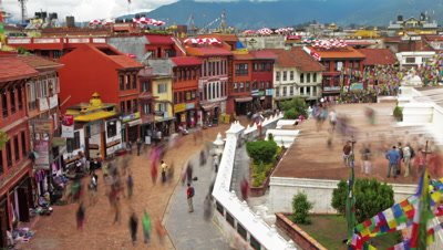 Time-lapse of people walking around the streets at Boudhanath Stupa in Kathmandu.