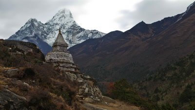 Time-lapse of a buddhist stupa with Ama Dablam peak in the background.