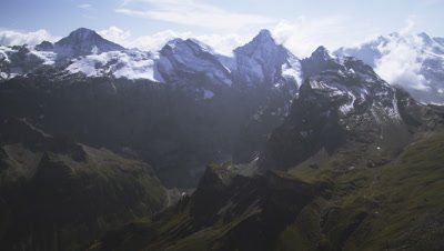 Wide static shot of Swiss Alps and clouds.