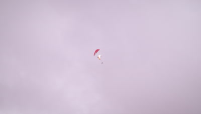 Long distance shot of two paragliders spinning closely to each other in Switzerland
