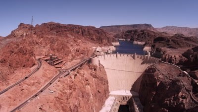 Static shot of hoover dam with cars driving.