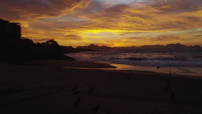 Tracking shot over Devil's beach (Praia do Diabo) at dusk - different frame rate