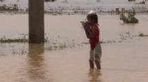 Child Stands Shivering In Flood Waters After Major Storm
