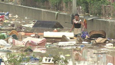 People Wade In Filthy Flood Waters In Manila Philippines