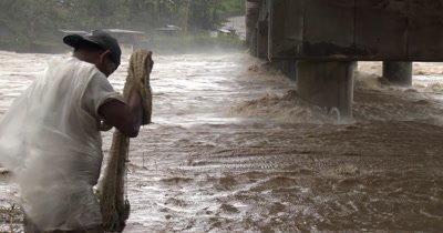Fishermen Tackle Raging Flood Waters In River