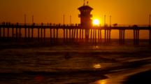 Golden Sunset, Silhouette Of Surfer Coming In, People On Pier,  Waves