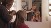 Women do Hair And Makeup for Modeling Shoot