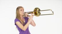 Woman Model In Studio With White Background Playing Trombone