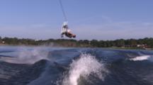 Wakeboarder-Behind Boat-Rides Into Shot And Backflips Over Wake